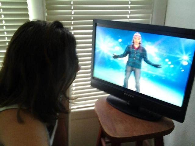 Girl sitting about 1.5ft from a TV screen