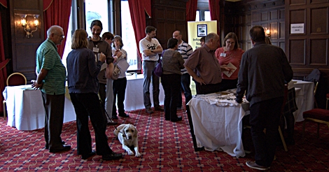 Delegates looking at exhibition stall and talking with each other