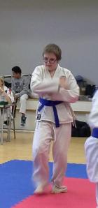 Elliott wearing a white gi with a purple belt