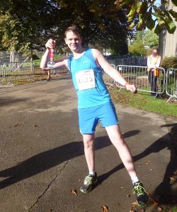Harry in running gear showing off his medal