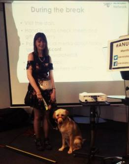 Fern Lulham and her guide dog Nancy in front of the projection screen