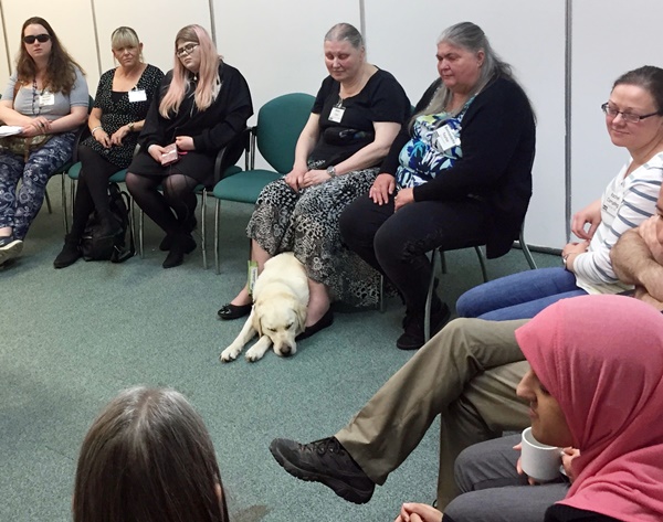 8 people with aniridia sitting in a crescent
