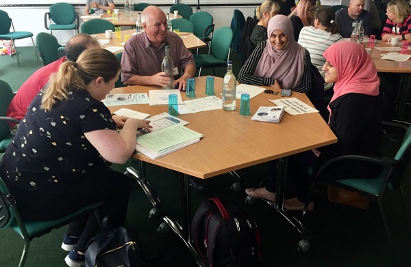 Haya and people affected by aniridia talking around a table