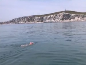 Nicola swimming towards French cliffs