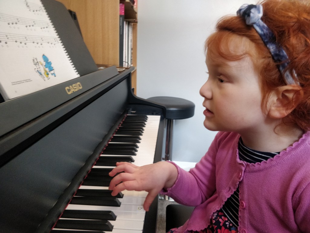 4 year old girl playing piano