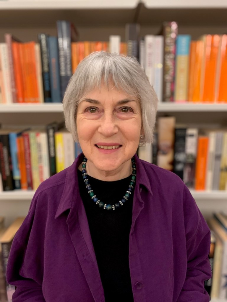 Woman in front of a large book case