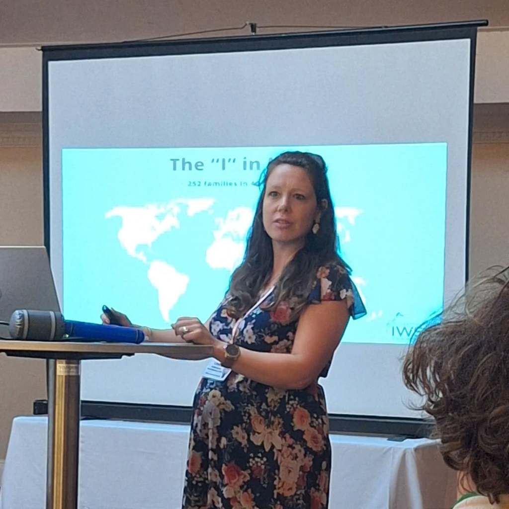 Linda presenting in front of a projection screen